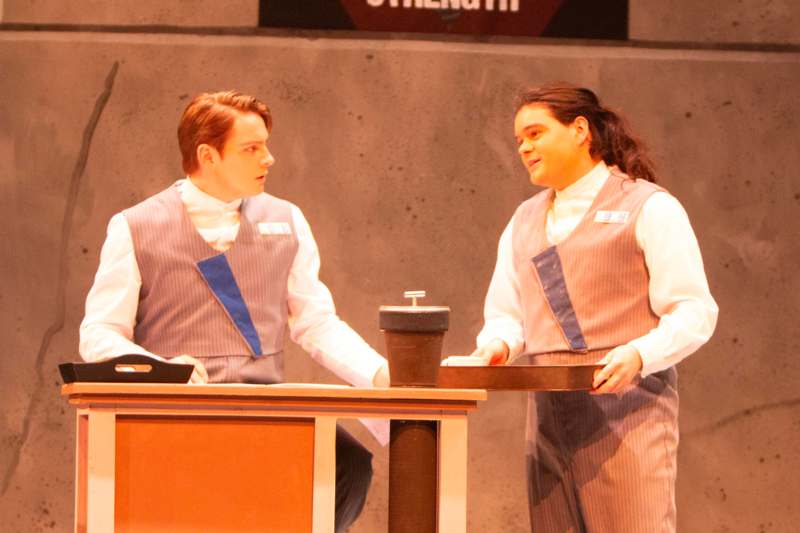 a man and woman standing at a table