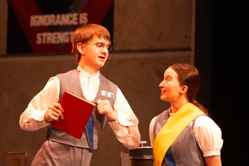 a man and woman in vests