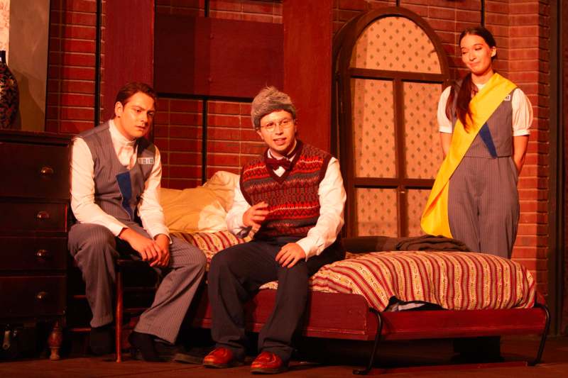 a group of people sitting on a bed