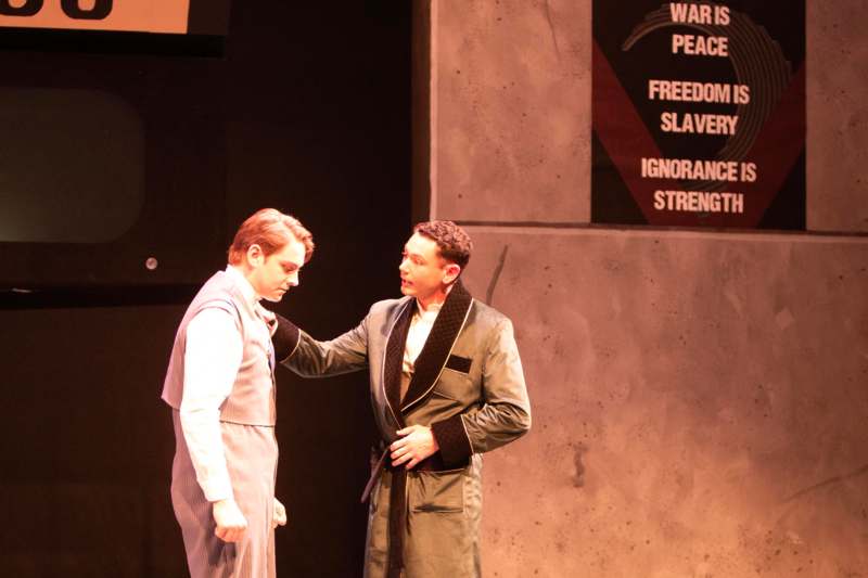 a man in a suit touching another man's waist