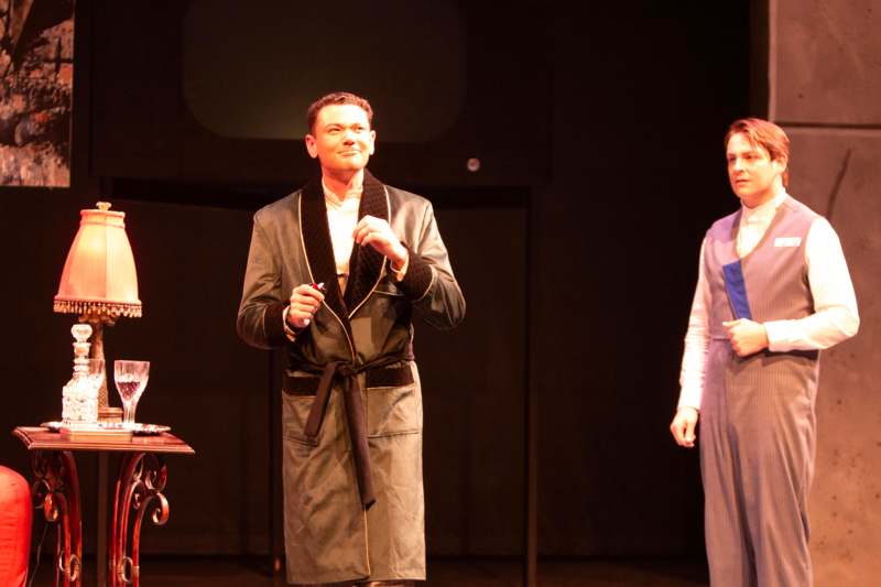 a man in a robe standing on a stage