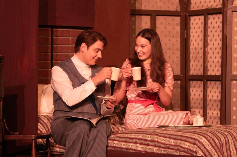 a man and woman holding cups and plates