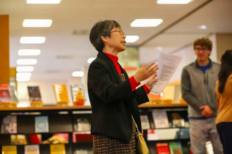 a woman holding a piece of paper