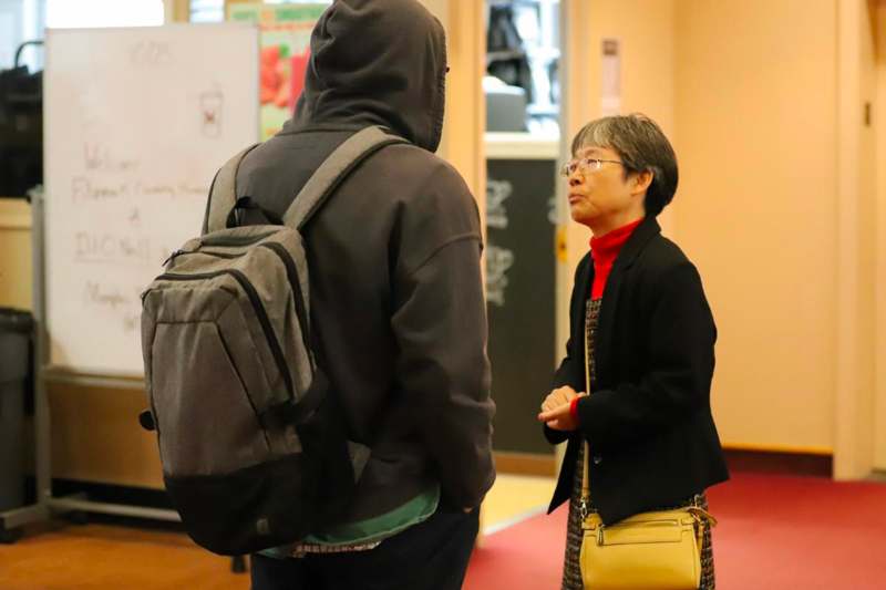 a woman standing in front of a man