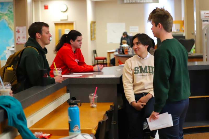 a group of people standing around a counter