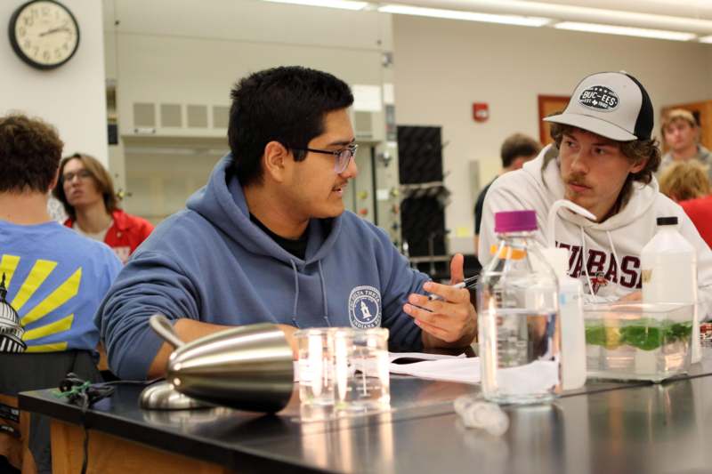 a group of men sitting at a table