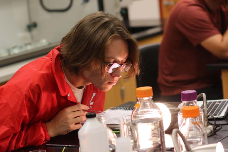 a man looking at a bottle