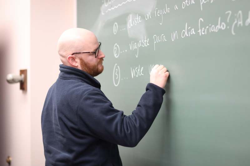 Classroom: SPA 202 with Professor Matthew Greenhalgh - a man writing on a chalkboard