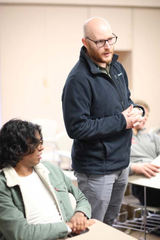 a man standing in front of a woman