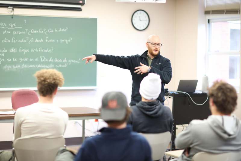 a man standing in front of a classroom