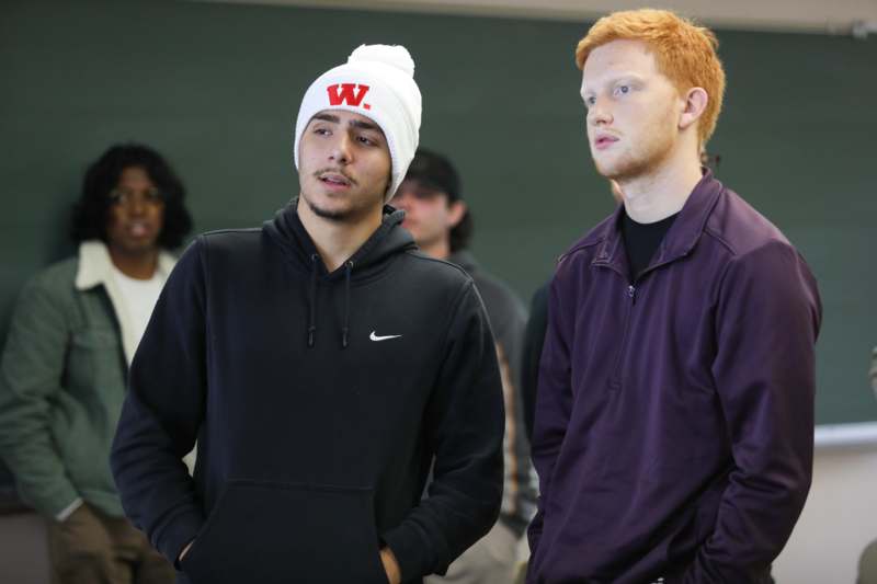 a man in a beanie and a man in a black sweatshirt