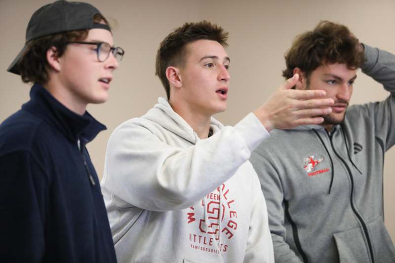 a group of men standing in a room