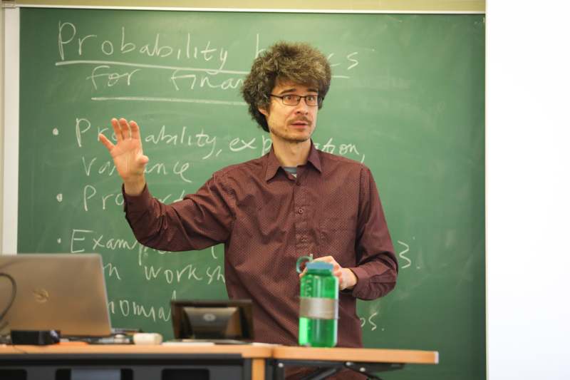 a man standing in front of a chalkboard