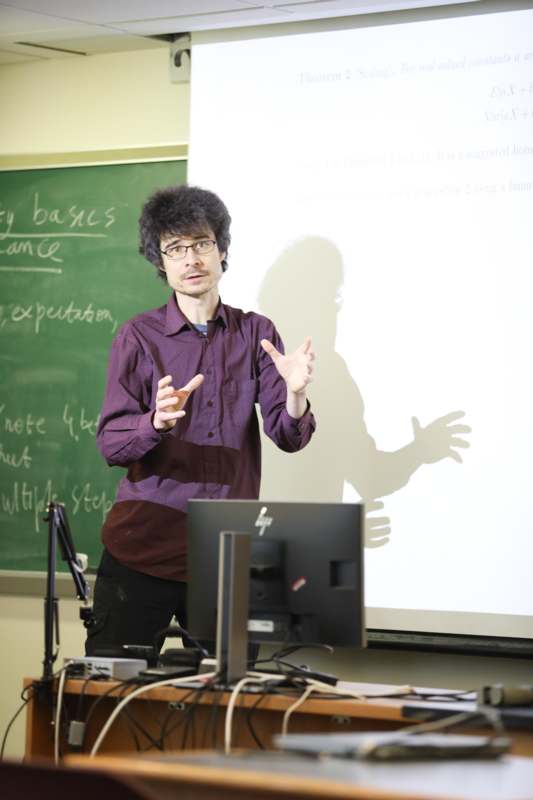a man standing in front of a white board