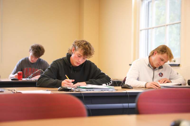 a group of people sitting at a desk