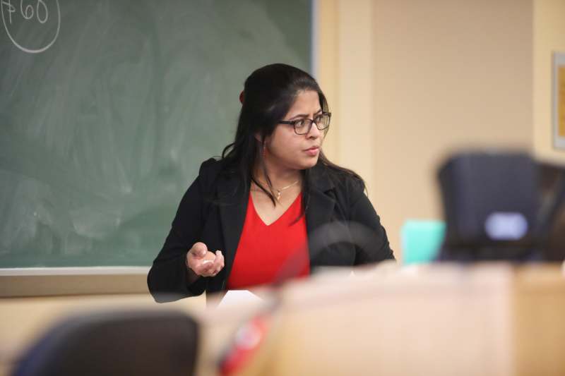 a woman in a red shirt and black jacket