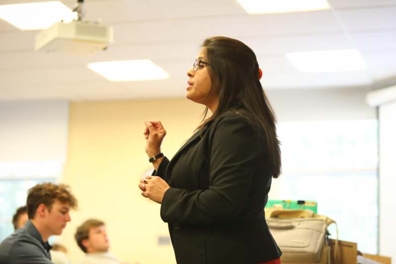 a woman standing in front of a group of people