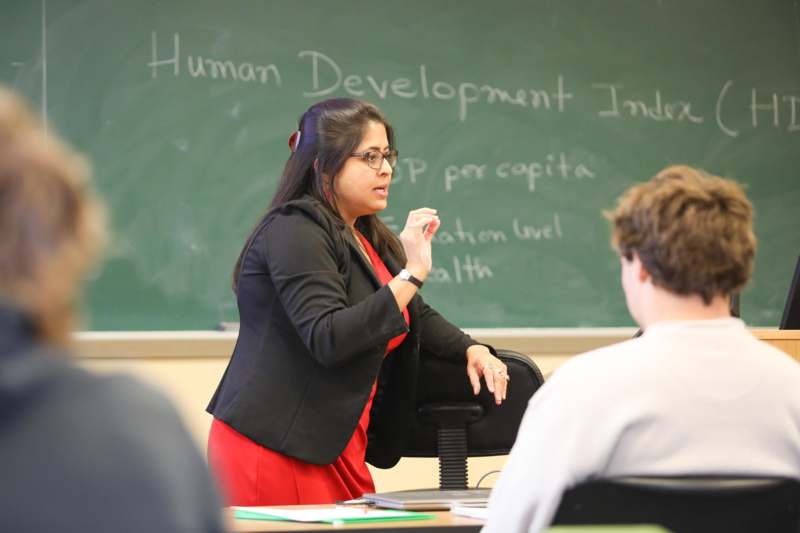 a woman standing in front of a chalkboard