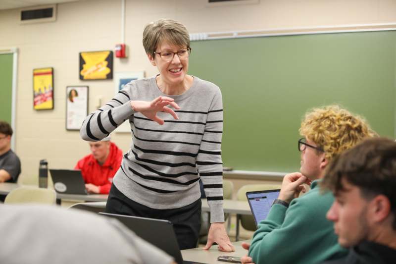 a woman standing in front of a group of people