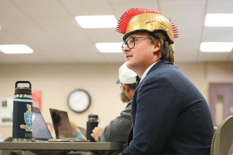 a man wearing a gold helmet with spikes on his head