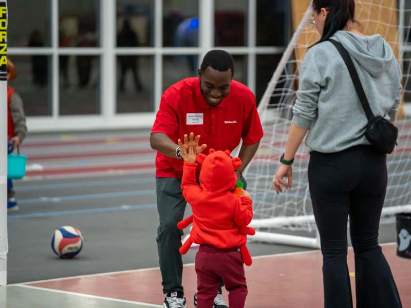 Halloween Event (10/30/25) - a man and child in a gym