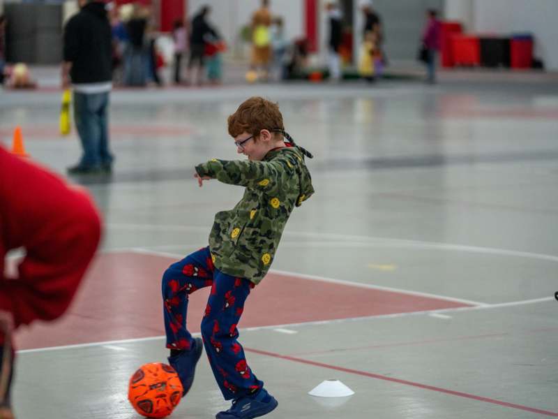 a boy kicking a ball