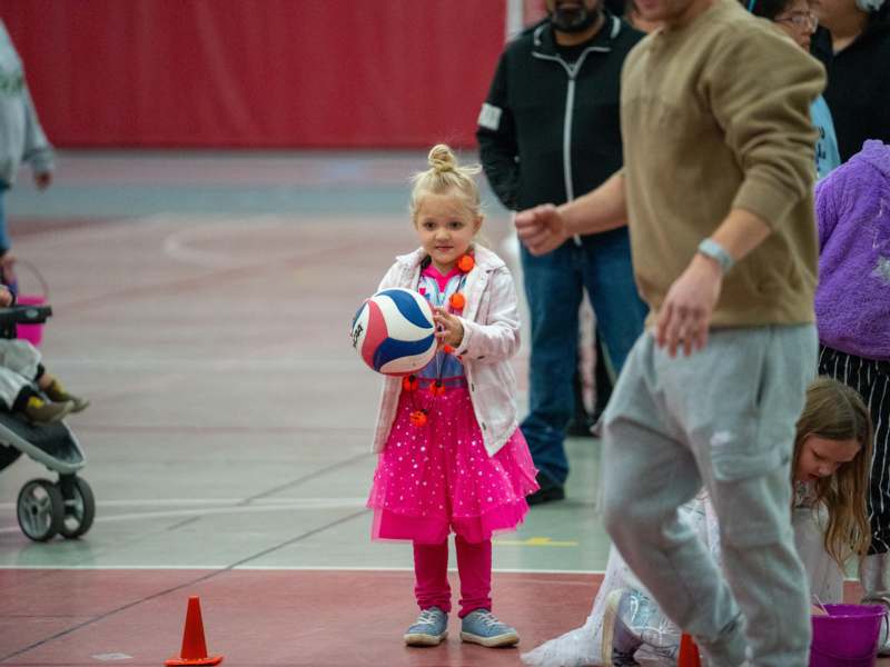 a girl holding a ball
