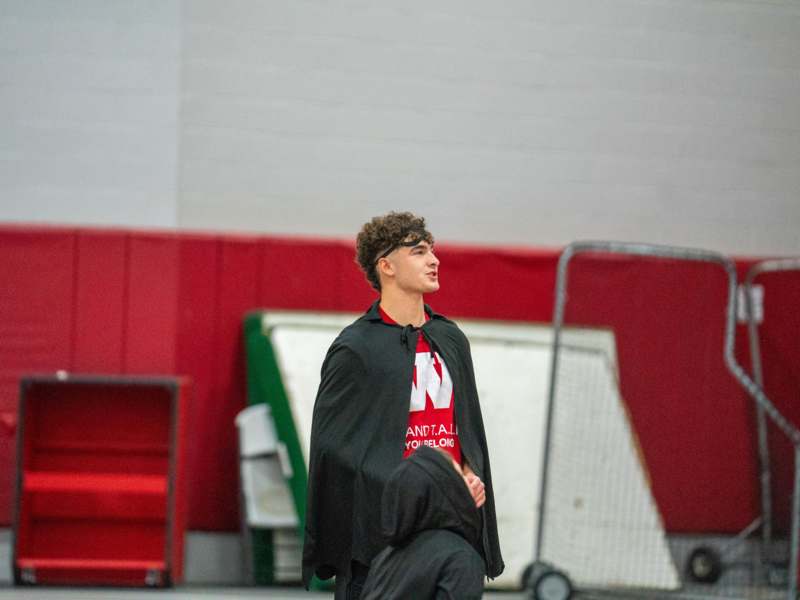 a man in a black cape