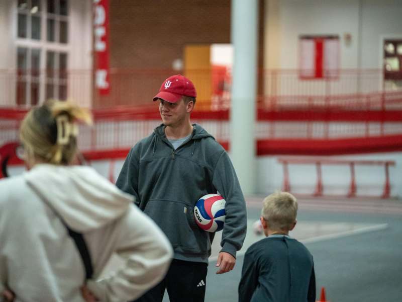 a man holding a ball in a gym