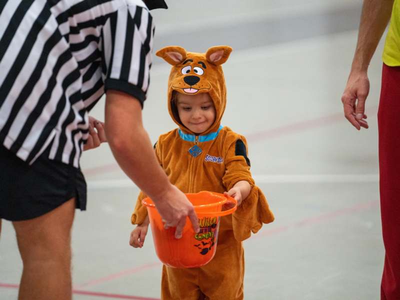 a child in a garment holding a bucket