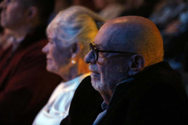 a man and woman sitting in a row