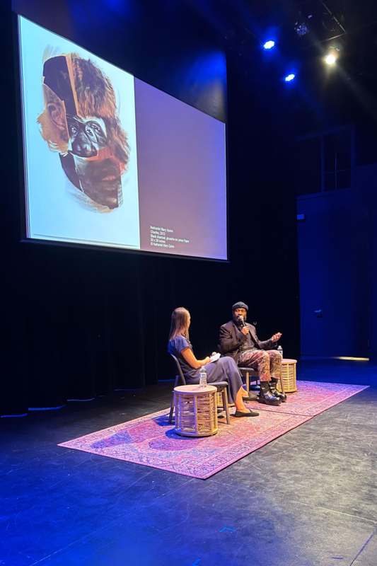 a man sitting on a chair with a woman on a stage