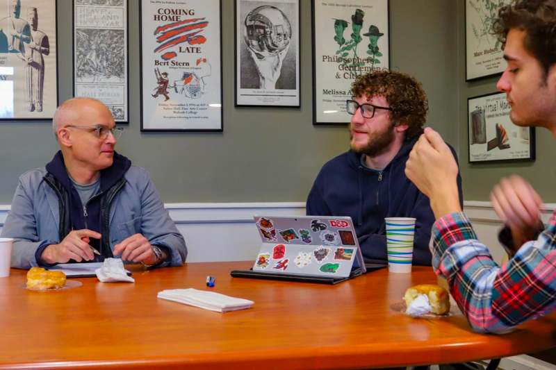 a group of men sitting at a table