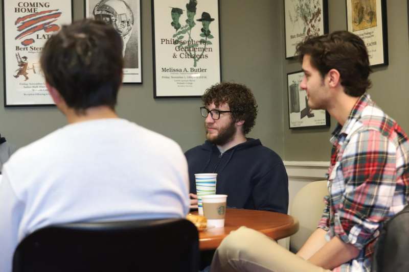 a group of men sitting at a table