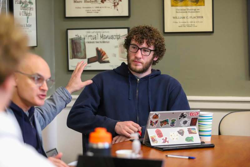 a man in a blue jacket talking to a man in a blue jacket