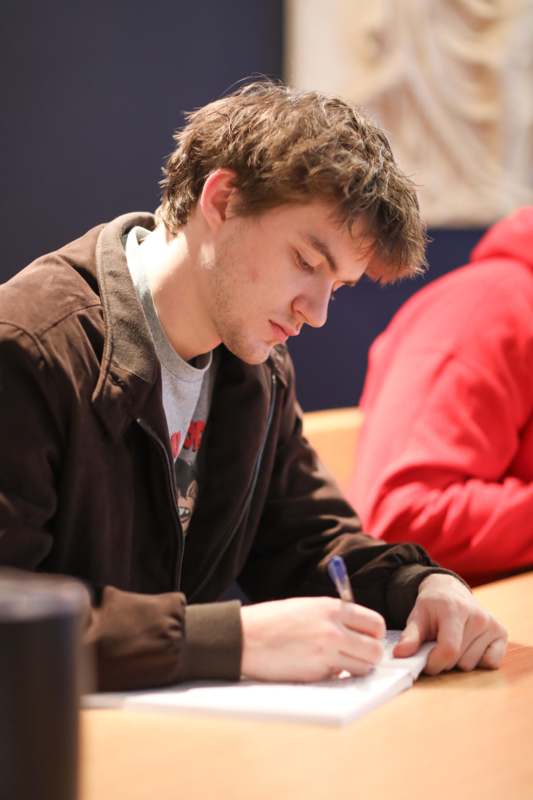 a man writing on a paper