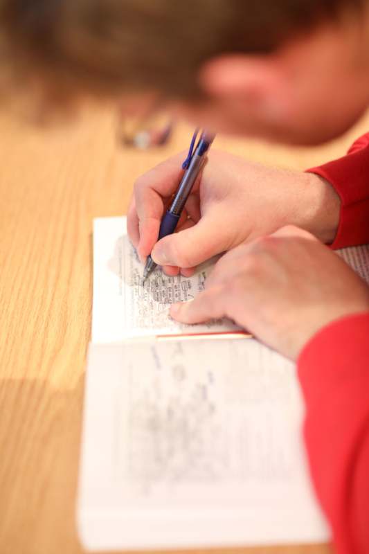 a person writing on a book