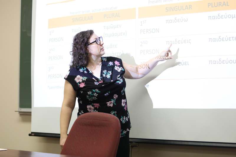 a woman pointing at a screen