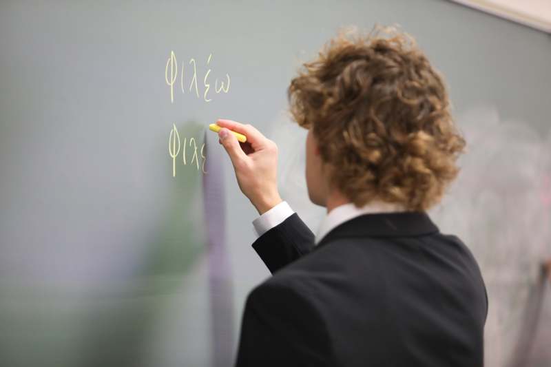 a person writing on a whiteboard