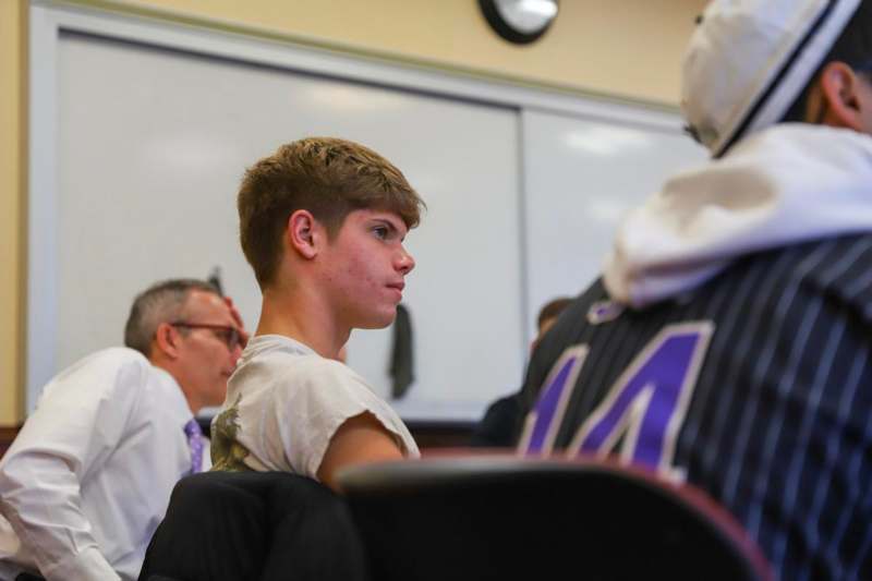 a boy sitting in a classroom