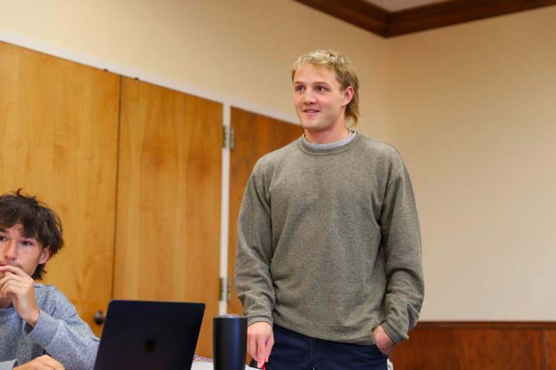 a man standing in front of a laptop