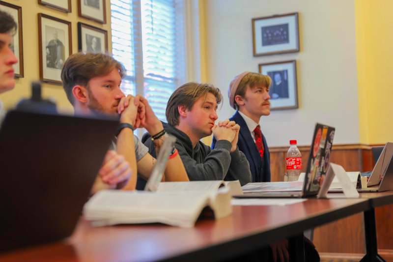 a group of men sitting at a table