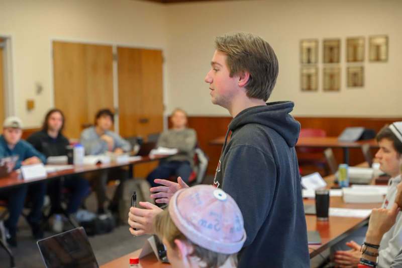 a man standing in front of a laptop