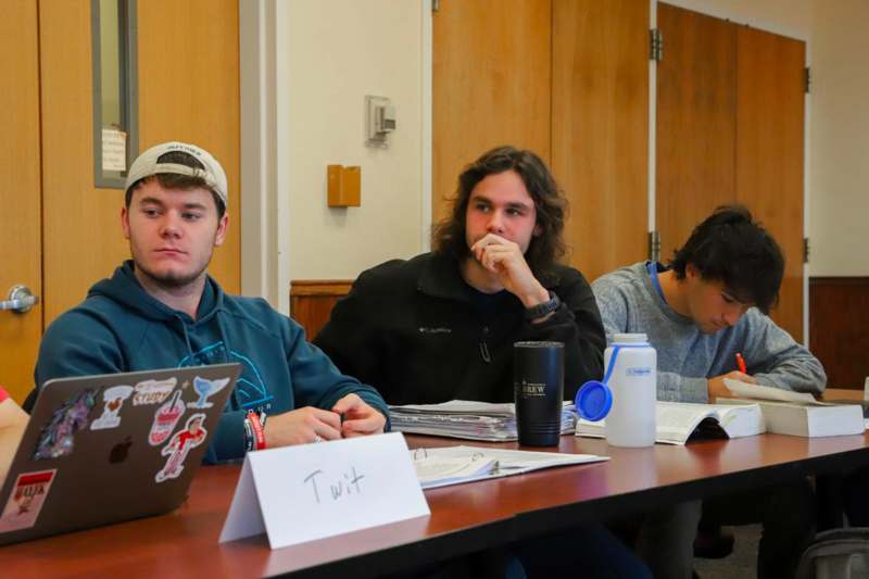 a group of men sitting at a table