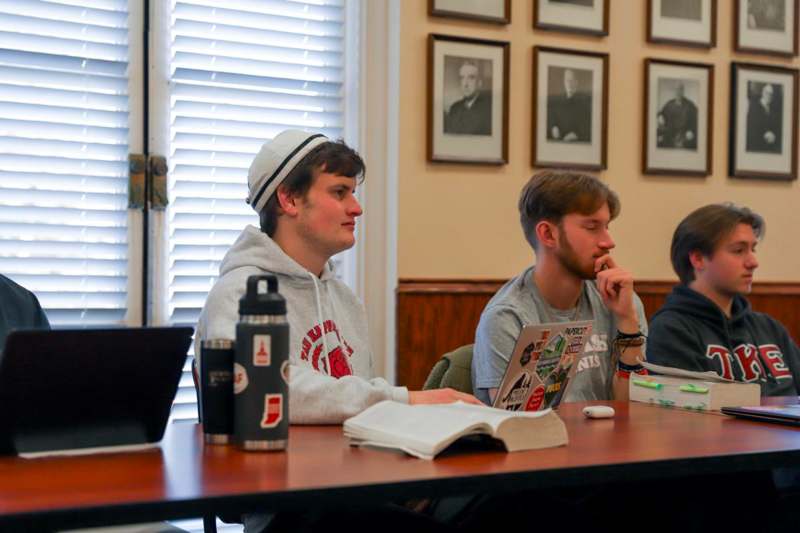 a group of men sitting at a table