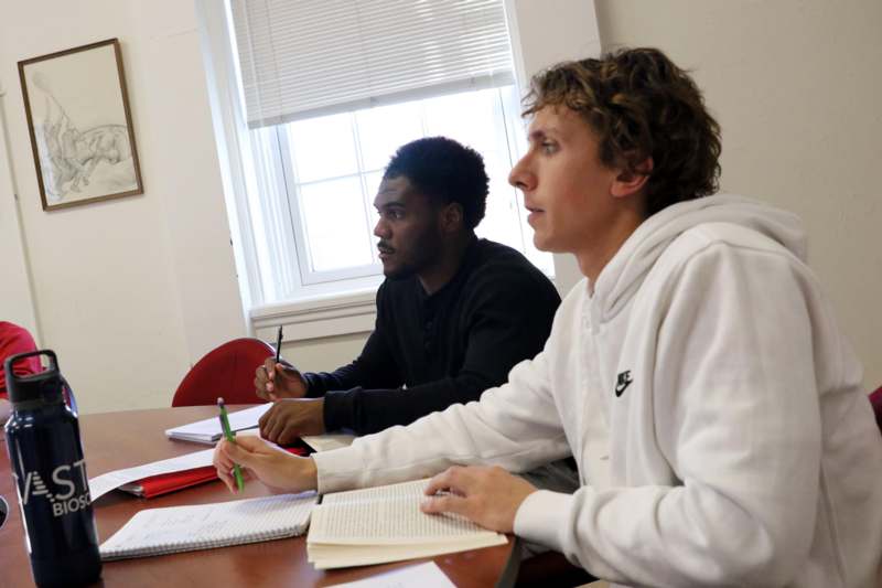 a group of men sitting at a table