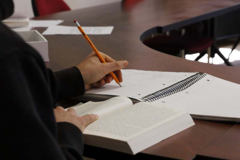 a person writing in a book