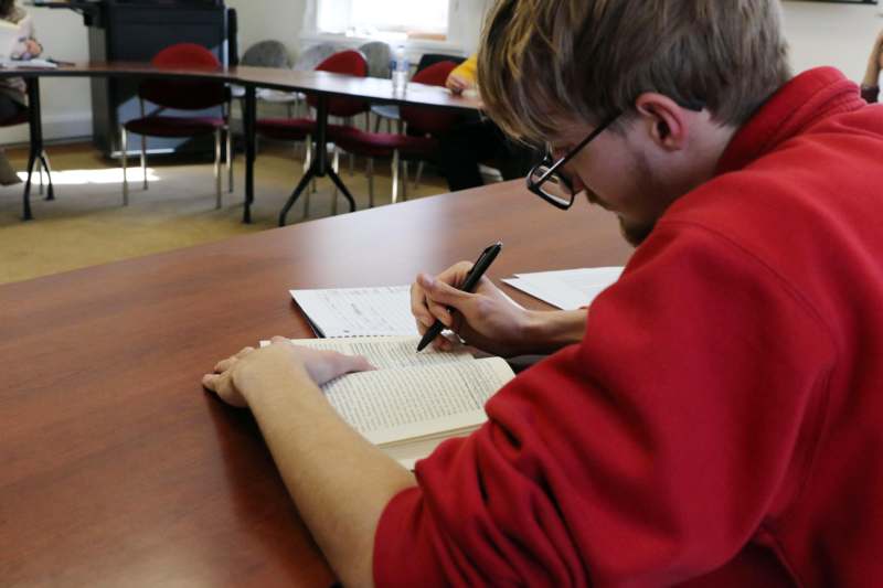 a man writing on a book