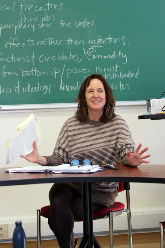 a woman sitting at a desk with a book