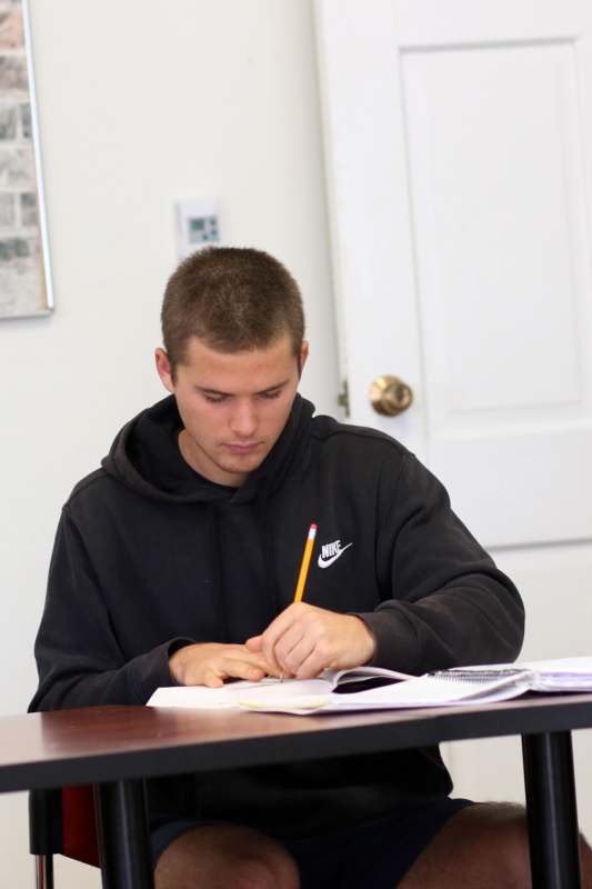 a man writing on a book